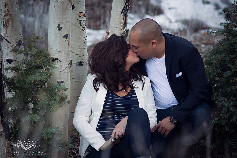 las vegas engagement photographer captures couple kissing by trees